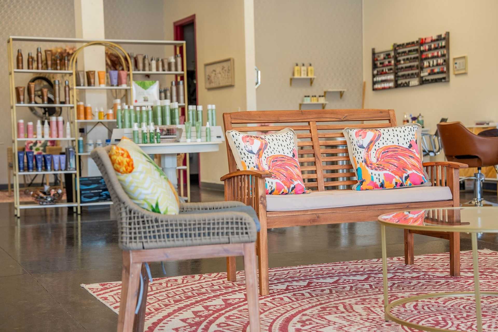 Interior of a salon with a bench, chair, and 100% organic product shelves.